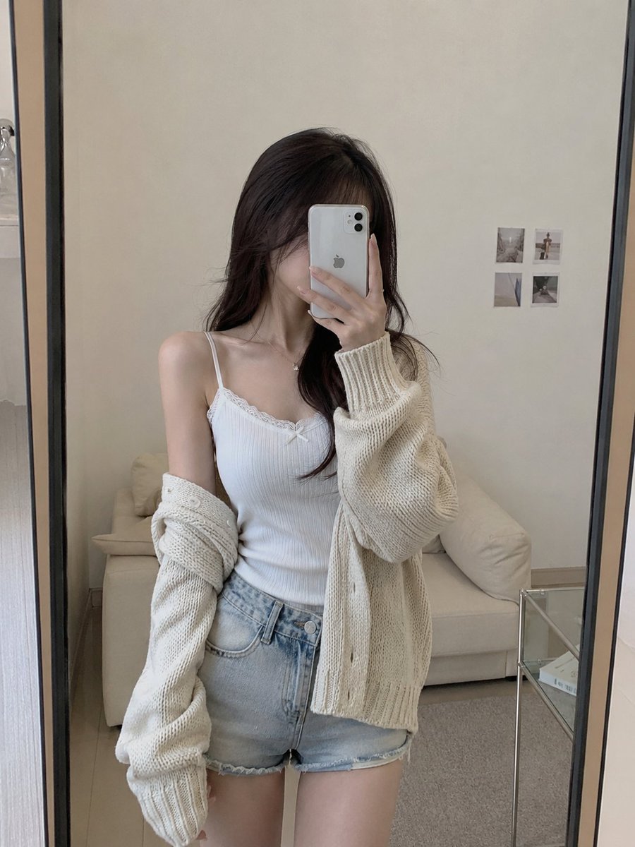 Photorealistic woman, minimalist bedroom, warm.